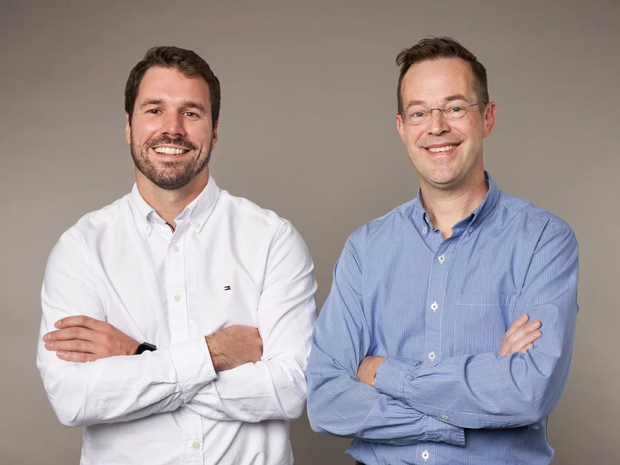 Dr. Darren Smith and Dr. Blair VanNostrand of Falmouth Dental Health, arms folded, smiling.