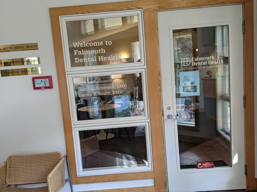 The front door of Falmouth Dental Health, with the practice name on the glass.